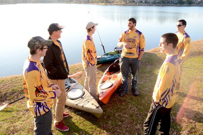 The LSU Kayak Fishing Club stands next to their Kayaks at Milford Wampold Memorial Park.