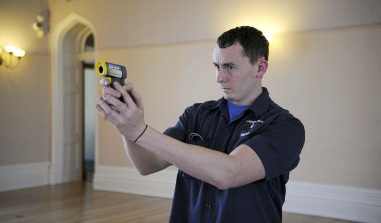 Martin DeLatte uses a temperature reader to detect changes in temperature indicative of paranormal activity Friday afternoon, Feb. 14, 2014 at the Louisiana Old State Capitol.