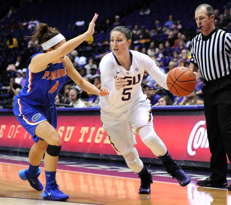 LSU senior guard Jeanne Kenney (5) attempts to ward off Florida sophomore guard Carlie Needles (4) Sunday, Jan. 12, 2014 during the Tigers' 82-68 victory against the Gators in the PMAC.