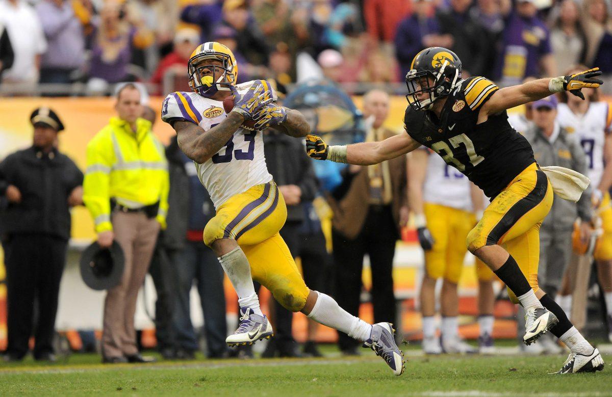 LSU sophomore running back Jeremy Hill (33) outruns junior defensive back John Lowdermilk for the touchdown Wednesday, Jan. 1, 2014 during the Tigers' 21-14 victory against the Iowa Hawkeyes in the Outback Bowl at Raymond James Stadium in Tampa, Florida.