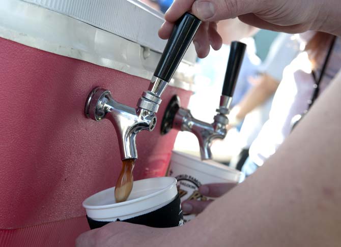 A brewer pours beer from a tap Saturday, Feb. 15, 2014 during the 2014 Brasseurs a la Maison Iron Brewer Festival at Tin Roof Brewing Company in Baton Rouge.