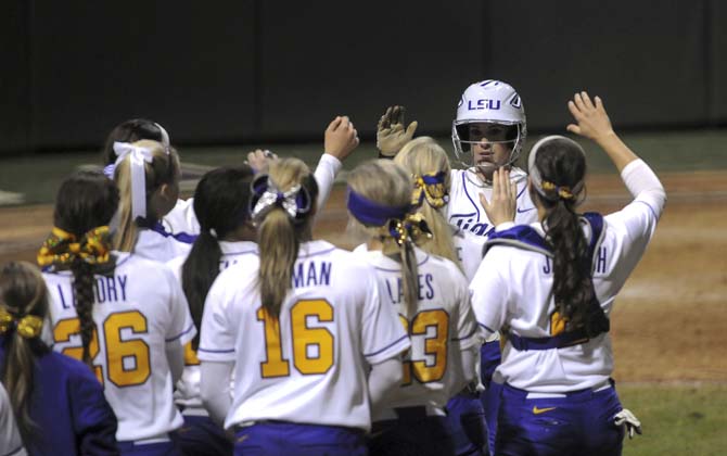 LSU sophomore infielder Sandra Simmons (3) celebrates with her teammates after getting LSU's lone run in a 1-0 victory against Oklahoma State on Saturday, Feb. 8, 2014 in Tiger Park.