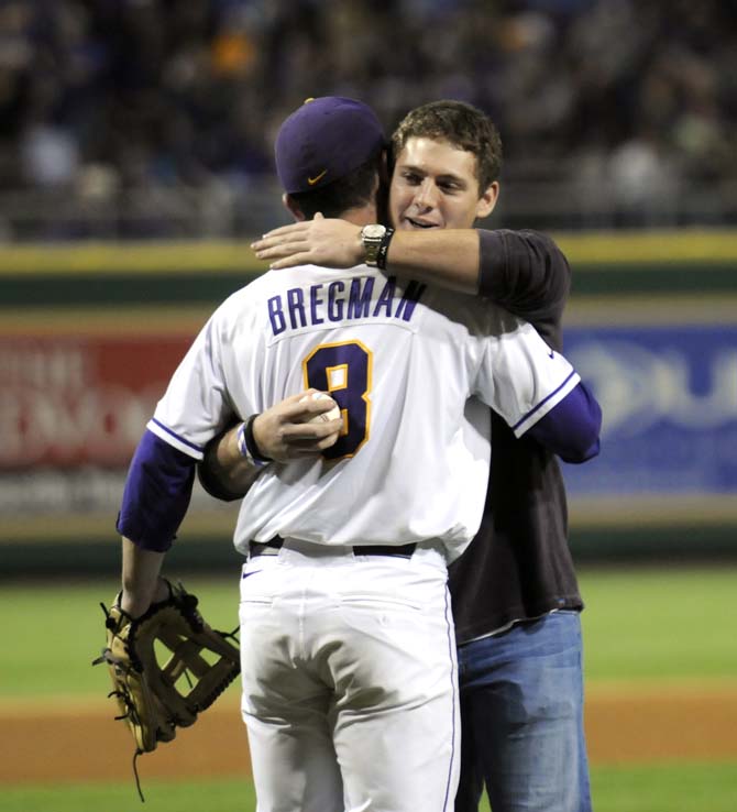 Former LSU first baseman Mason Katz hugs current sophomore shortstop Alex Bregman (8) before the Tigers' 2-0 win against UNO in Alex Box Stadium on Friday, Feb. 14, 2014.