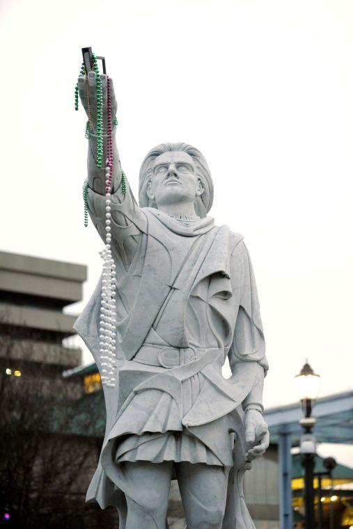 A statue in downtown Baton Rouge is strung with Mardi Gras beads Saturday, Feb. 22, 2013 before the Krewe of Orion parade.