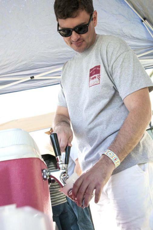 A brewer pours beer from a tap Saturday, Feb. 15, 2014 during the 2014 Brasseurs a la Maison Iron Brewer Festival at Tin Roof Brewing Company in Baton Rouge.