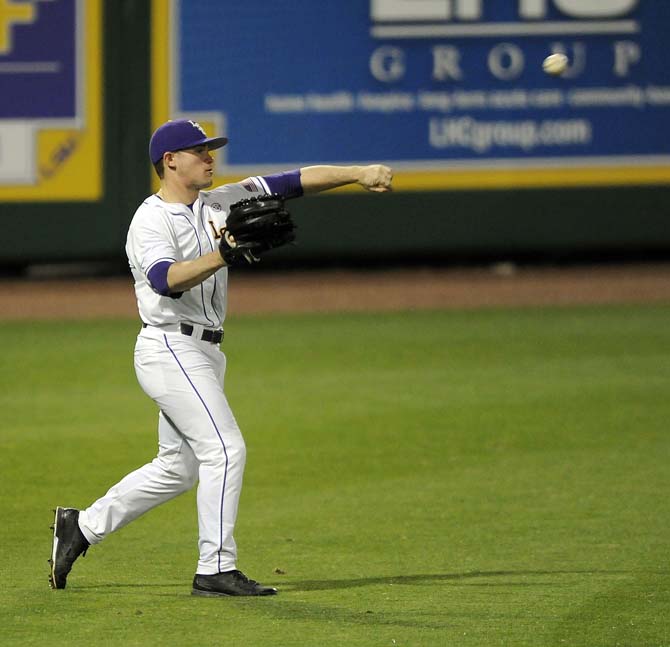 LSU senior outfielder Sean McMullen (7) throws the ball Friday, Feb. 28, 2014 during the Tigers' win against Yale in Alex Box Stadium.