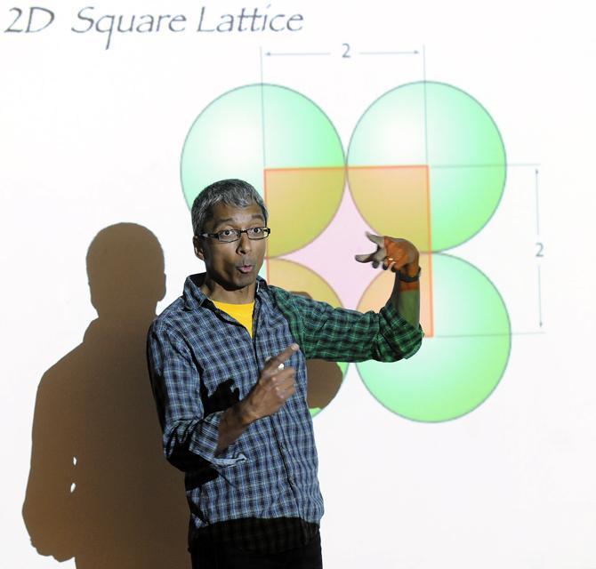 Dr. Satyan Devadoss, professor of mathematics at Williams College, speaks about 2D Square Lattices Wednesday, Feb. 26, 2013 during the LSU mathematics department student colloquium on packing and partitions in Lockett Hall.