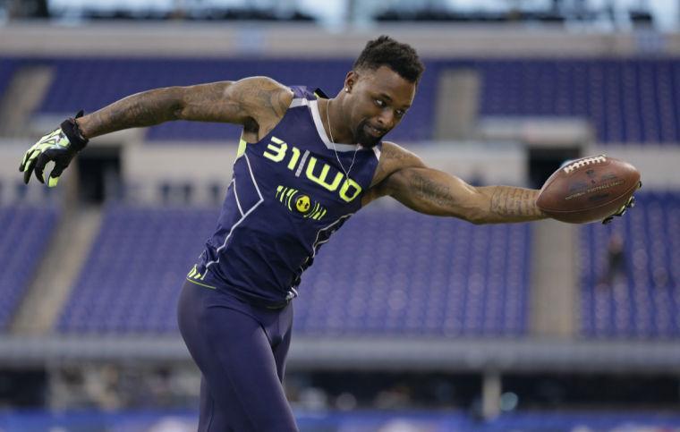 Louisiana State wide receiver Jarvis Landry makes a one-handed catch during a drill at the NFL football scouting combine in Indianapolis, Sunday, Feb. 23, 2014. (AP Photo/Michael Conroy)