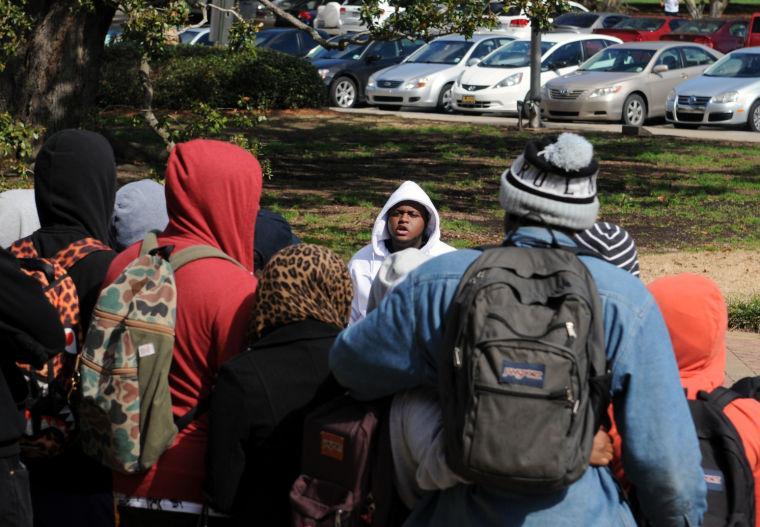 Mass communication senior Myron Smothers speaks to a group of students about remembering Trayvon Martin on Wednesday, Feb. 4, 2014 on the steps of Memorial Tower.