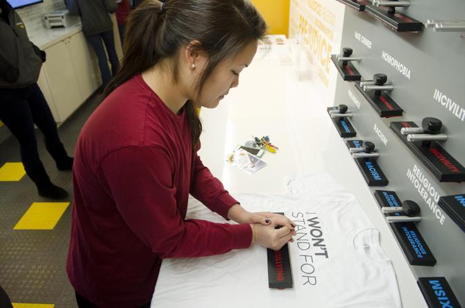 Tamho Ang, a Senior at LSU majoring in Pre-Pharmacy, stamps "Bullying" onto her shirt provided by USA's Character Search Month "I Won't Stand For..." campaign.