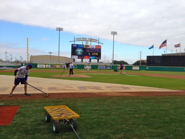 The Alex Box Stadium maintenance team prepares the field for players' practice following Media day.