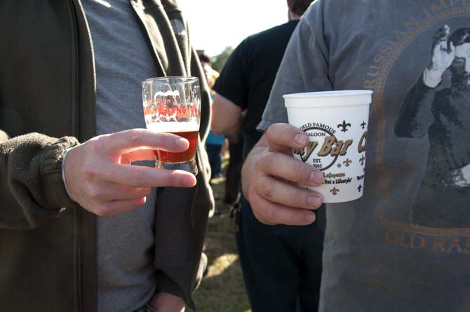 Two patrons hold out their beer samples Saturday, Feb. 15, 2014 during the 2014 Brasseurs a la Maison Iron Brewer Festival at Tin Roof Brewing Company in Baton Rouge.