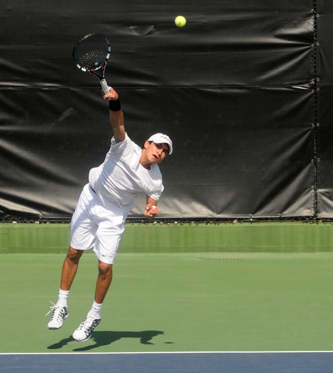 LSU freshman tennis player Justin Butsch serves the ball Sunday, Feb. 9, 2014 during the Tigers' 6-1 victory against Southern Miss in W.T. "Dub" Robinson Tennis Stadium.