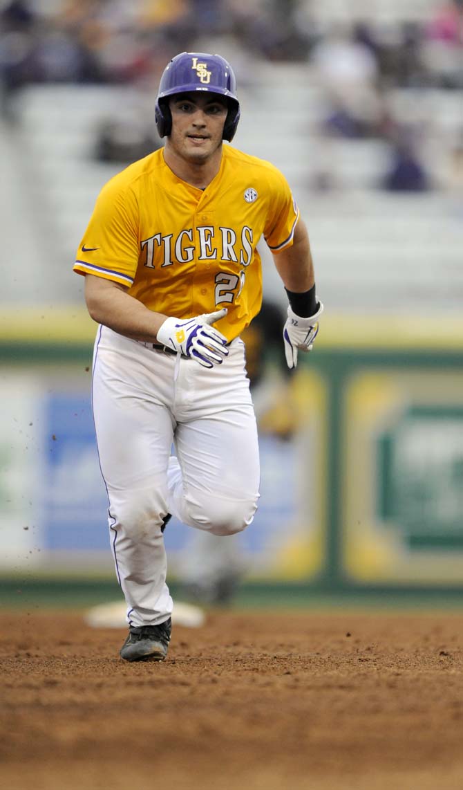 LSU sophomore catcher Chris Chinea (26) runs to third base Sunday, Feb. 16, 2014 during the Tigers' 6-0 victory against Grambling State University in Alex Box Stadium.