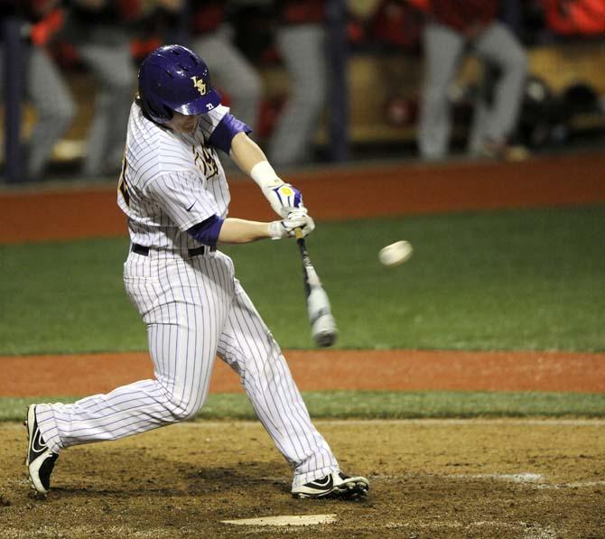 LSU junior catcher Kade Scivicque (22) hits the ball Tuesday, Feb. 25, 2014, during the Tigers' 4-1 win against Texas Southern in Alex Box Stadium.