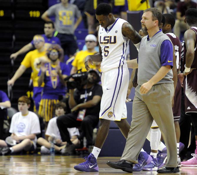 LSU senior forward Shavon Coleman (5) is walked off the court after being injured Wednesday Feb. 19, 2014 during the Tigers' 92-81 victory against Mississippi State in the PMAC.