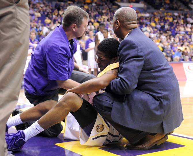 LSU head beasketball coach Johnny Jones helps sophomore guard Malik Morgan (24) after Morgan injusted his knee Saturday, Feb. 8, 2013 during the Tigers' 87-80 victory against the Auburn Tigers in the PMAC.