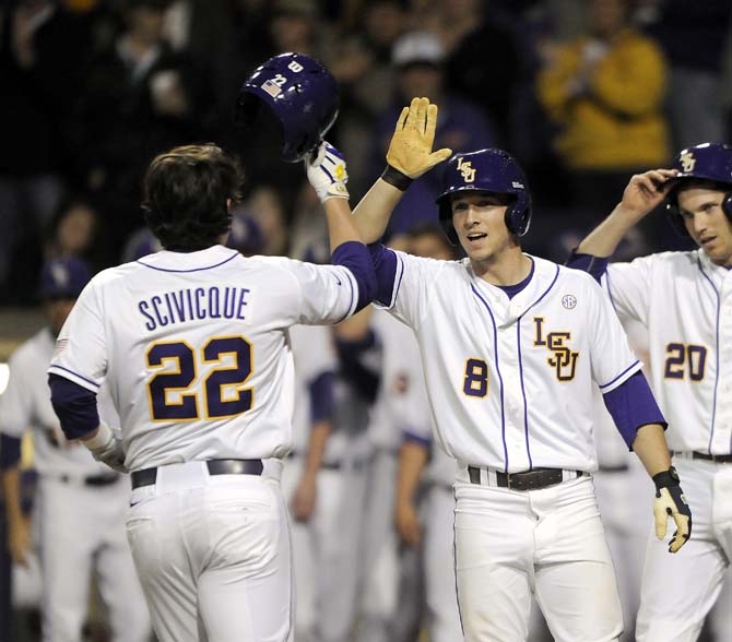 LSU sophomore infielder Alex Bregman (8) congratulates junior catcher Kade Scivicque (22) after Scivicque's home run in the first inning of the Friday, Feb. 28, 2014 game against Yale in Alex Box Stadium.