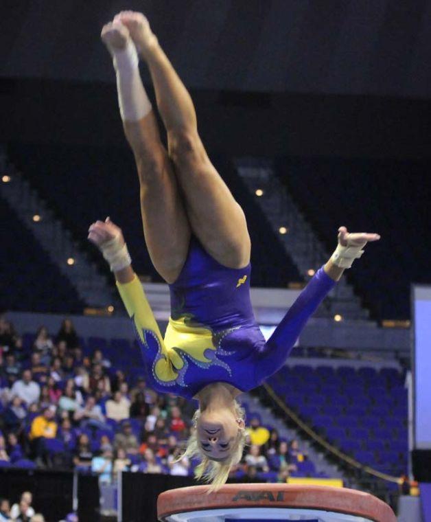 LSU senior all-around gymnast Sarie Morrison flips off the vault Friday, Feb. 28, 2014 during the Tigers' 198.050-194.825 victory against Missouri at the PMAC.