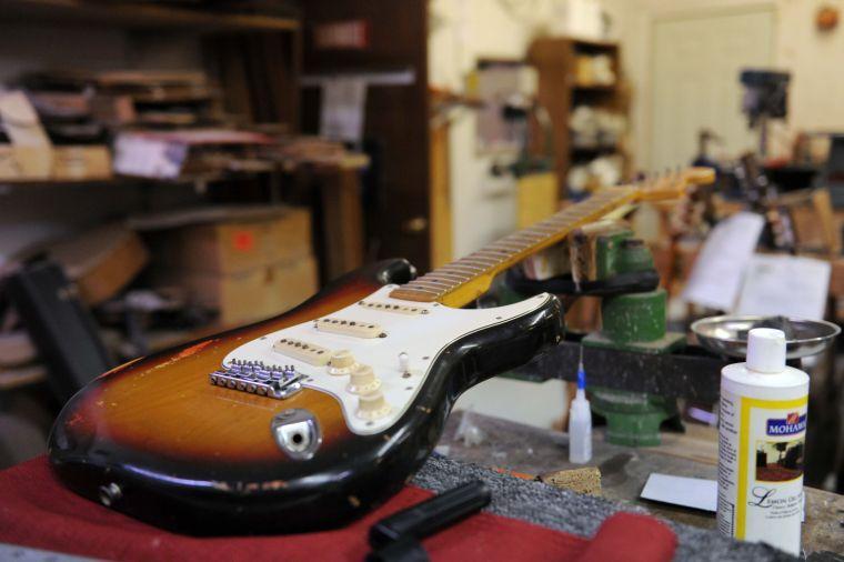 A 1970s era electric guitar awaits repair Friday afternoon Feb. 7, 2014 at Tim's Guitar Repair and Workshop.