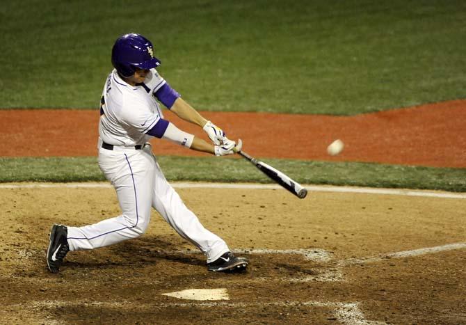 LSU senior infielder Christian Ibarra (14) hits a home run Feb. 28, 2014 during the Tigers' 19-0 win against Yale in Alex Box Stadium.