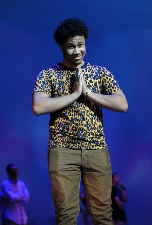 ISDS junior Brandon Gorrden gestures to the audience Tuesday, Feb. 4, 2014 during the Mister and Miss Imani Scholarship Pageant: “A Walk in Their Shoes…” in the LSU Union Theatre.