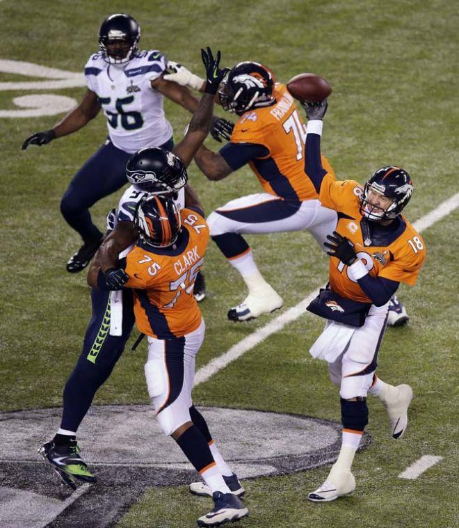 Denver Broncos' Peyton Manning (18) throws against against the Seattle Seahawks during the first half of the NFL Super Bowl XLVIII football game Sunday, Feb. 2, 2014, in East Rutherford, N.J. (AP Photo/Charlie Riedel)