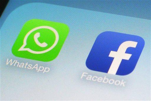 This Wednesday, Feb. 19, 2014 photo shows the WhatsApp and Facebook app icons on an iPhone in New York. On Wednesday the world's biggest social networking company, Facebook, announced it is buying mobile messaging service WhatsApp for up to $19 billion in cash and stock. (AP Photo/Patrick Sison)