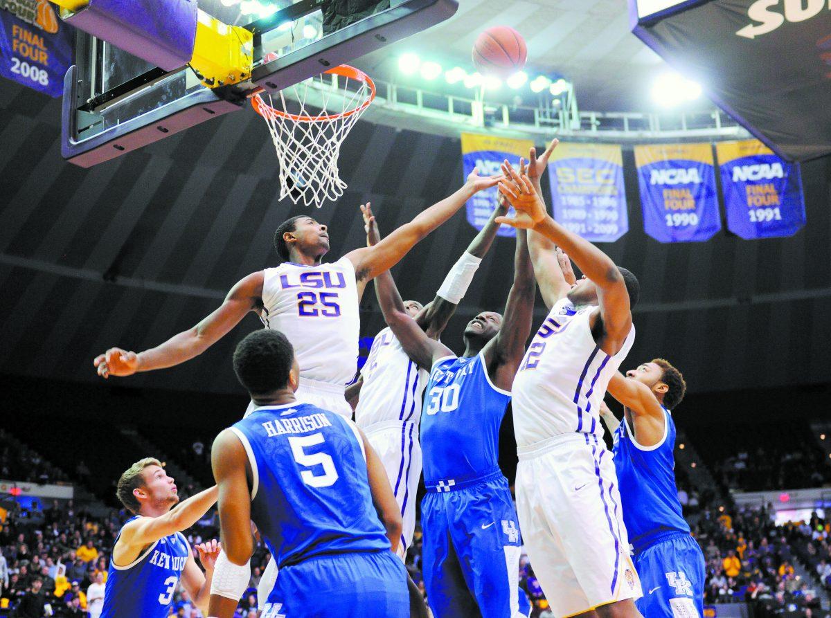 LSU freshman forward Jordan Mickey (25) and his teammates reach for the ball amongst Kentucky defenders Tuesday, Jan. 28, 2014 during the Tigers' 87-82 victory against Wildcats.