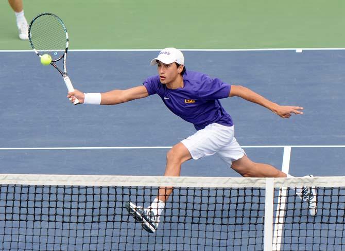 LSU freshman Justin Butsch stretches to return the volley Saturday, Feb. 8, 2013 during the Tigers' doubles match at W.T. "Dub" Robinson Stadium.