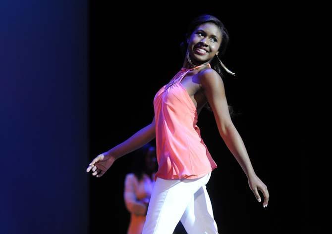 Public relations junior JoLena Broussard struts across the stage Tuesday, Feb. 4, 2014 during the Mister and Miss Imani Scholarship Pageant: “A Walk in Their Shoes…” in the LSU Union Theatre.