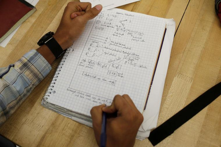 A student writes notes in the Advanced Placement (AP) Physics class at Woodrow Wilson High School in Washington, Friday, Feb. 7, 2014. The College Board says in a new report that the number of U.S. public students taking Advanced Placement classes doubled over the last decade. The class of 2013 of took 3.2 million AP exams. (AP Photo/Charles Dharapak)