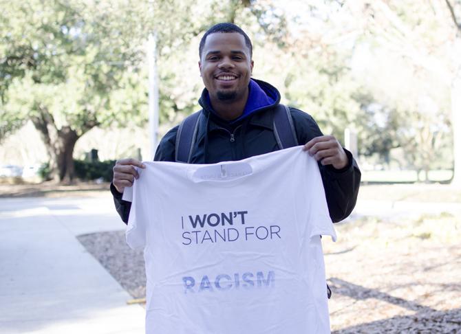 Theodore Davis IV, a Freshman at LSU for Psychology, stands holding his USA Characters Unite "I Won't Stand For..." t-shirt.