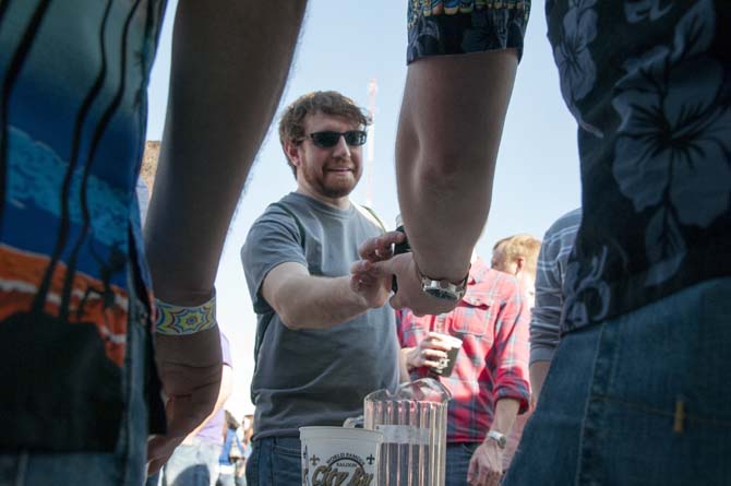 A patron takes a sample of beer at a booth Saturday, Feb. 15, 2014 during the 2014 Brasseurs a la Maison Iron Brewer Festival at Tin Roof Brewing Company in Baton Rouge.