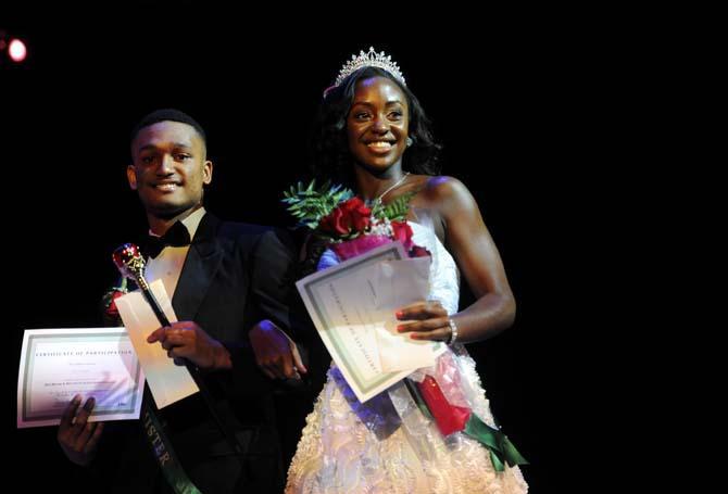 Broadcast journalism junior Kendra Turley (right) and finance freshman Alex James (left) walk the stage Tuesday, Feb. 4, 2014 after winning the Mister and Miss Imani Scholarship Pageant: “A Walk in Their Shoes…” in the LSU Union Theatre.