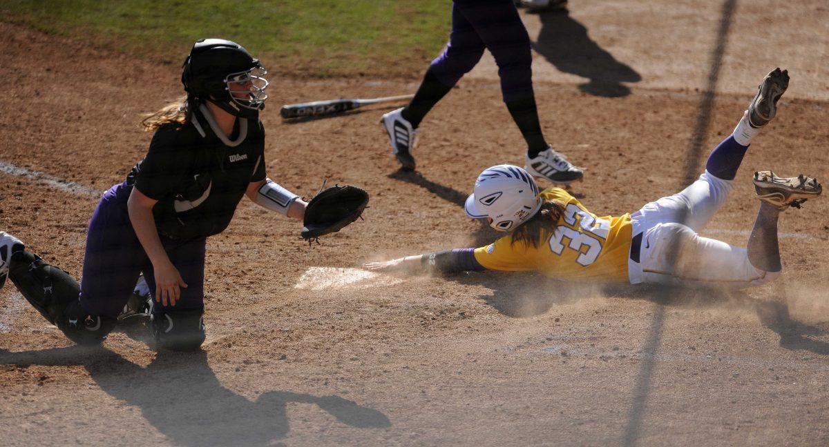 LSU red-shirt senior Allison Falcon (32) slides into home plate Sunday, Feb. 9, 2014 during the Lady Tigers' 8-1 victory against Central Arkansas at Tiger Park.