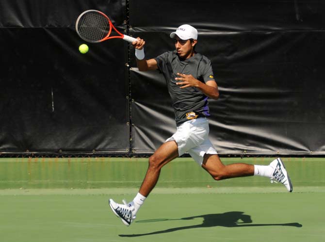 LSU sophomore tennis player Boris Arias runs to hit the ball Sunday, Feb. 9, 2014 during the Tigers' 6-1 victory against Southern Miss in W.T. "Dub" Robinson Tennis Stadium.