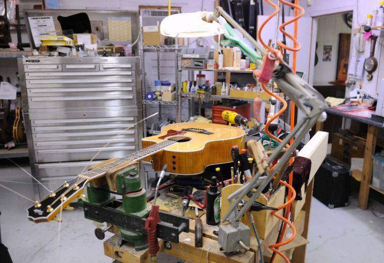 An acoustic guitar lays on the shop table Feb. 7, 2014 at Tim's Guitar Repair and Workshop.