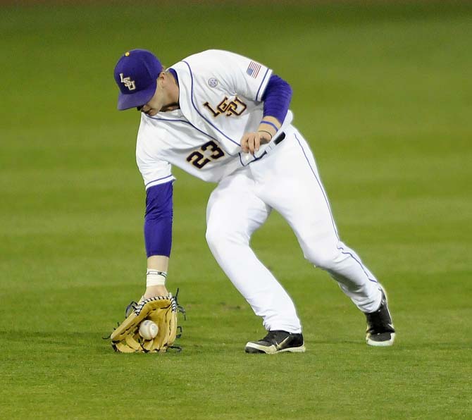 LSU freshman outfielder Jake Fraley (23) fields a ball Friday, Feb. 28, 2014 during the Tigers' 19-0 win against Yale in Alex Box Stadium.