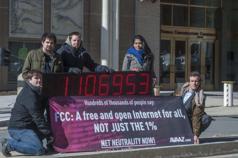 IMAGE DISTRIBUTED FOR AVAAZ - Members of global advocacy group Avaaz stand next to a digital counter showing the number of petition signatures calling for net neutrality outside the Federal Communication Commission in Washington, Thursday, Jan. 30, 2014. Avaaz joined other US advocacy groups to deliver more than a million signatures for a free and democratic internet to the FCC. (Kevin Wolf/AP Images for Avaaz)