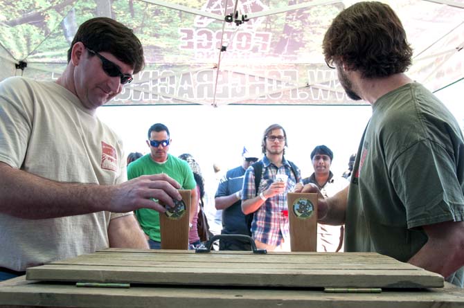 Brewers pour beers from taps for awaiting patrons Saturday, Feb. 15, 2014 during the 2014 Brasseurs a la Maison Iron Brewer Festival at Tin Roof Brewing Company in Baton Rouge.