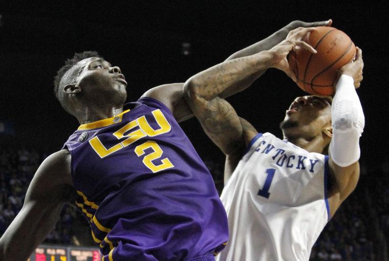 LSU's Johnny O'Bryant III (2) fouls Kentucky's James Young (1) during overtime in an NCAA college basketball game, Saturday, Feb. 22, 2014, in Lexington, Ky. Kentucky won 77-76. (AP Photo/James Crisp)