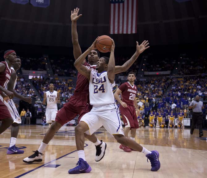 LSU sophomore guard Malik Morgan (24) avoids a defender Saturday, Feb. 2, 2014, during the Tigers' 88-74 victory against Arkansas in the PMAC.