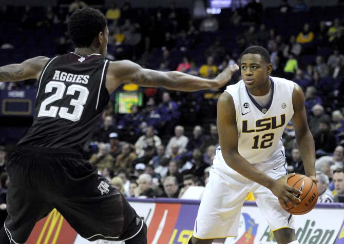 LSU freshman forward Jarell Martin (12) protects the ball from Texas A&amp;M junior guard Jamal Jones (23) Wednesday, Feb. 26, 2014 during the Tigers' 68-49 victory against the Aggies in the PMAC.