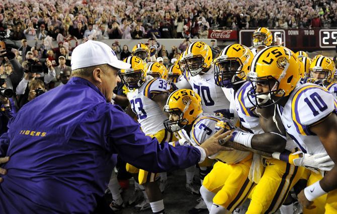 LSU head coach Les Miles holds back the players Saturday, Nov. 9, 2013 before the Tiger's 38-17 loss to the Alabama Crimson Tide at Bryant-Denny Stadium in Tuscaloosa, AL.