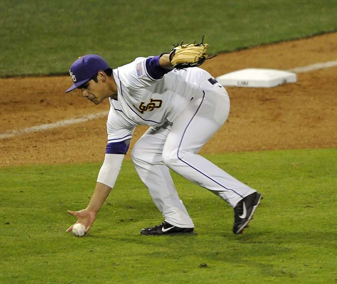 LSU senior infielder Christian Ibarra (14) fields a ball Feb. 28, 2014 during the Tigers' 19-0 win against Yale in Alex Box Stadium.