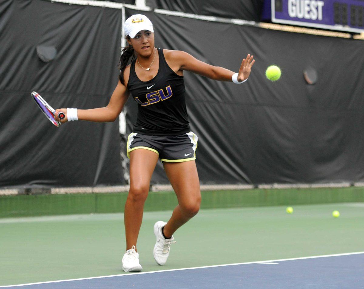 Gabrielle Otero, a new freshman on the women's tennis team, hits a ball at practice Tuesday, September 10, 2013.