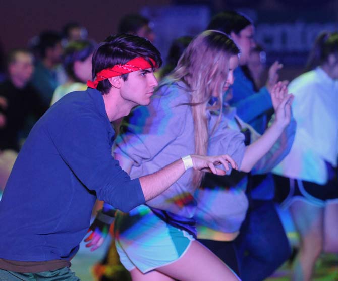 Students and event staff participate in a "morale dance" at the top of the hour Saturday, Feb. 22, 2014 at the Dance Marathon event in the John M. Parker Coliseum.