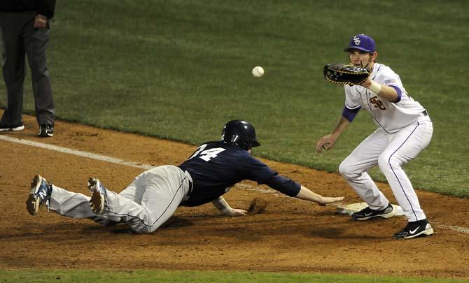 LSU junior infielder Connor Hale (20) tries to get Yale junior catcher Robert Baldwin (34) out Feb. 28, 2014 during the Tigers' 19-0 win against the Bulldogs in Alex Box Stadium.