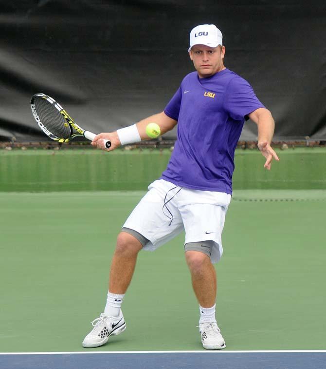 LSU sophomore Andrew Korinek returns a serve Saturday, Feb. 8, 2013 during the Tigers' doubles match at W.T. "Dub" Robinson Stadium.